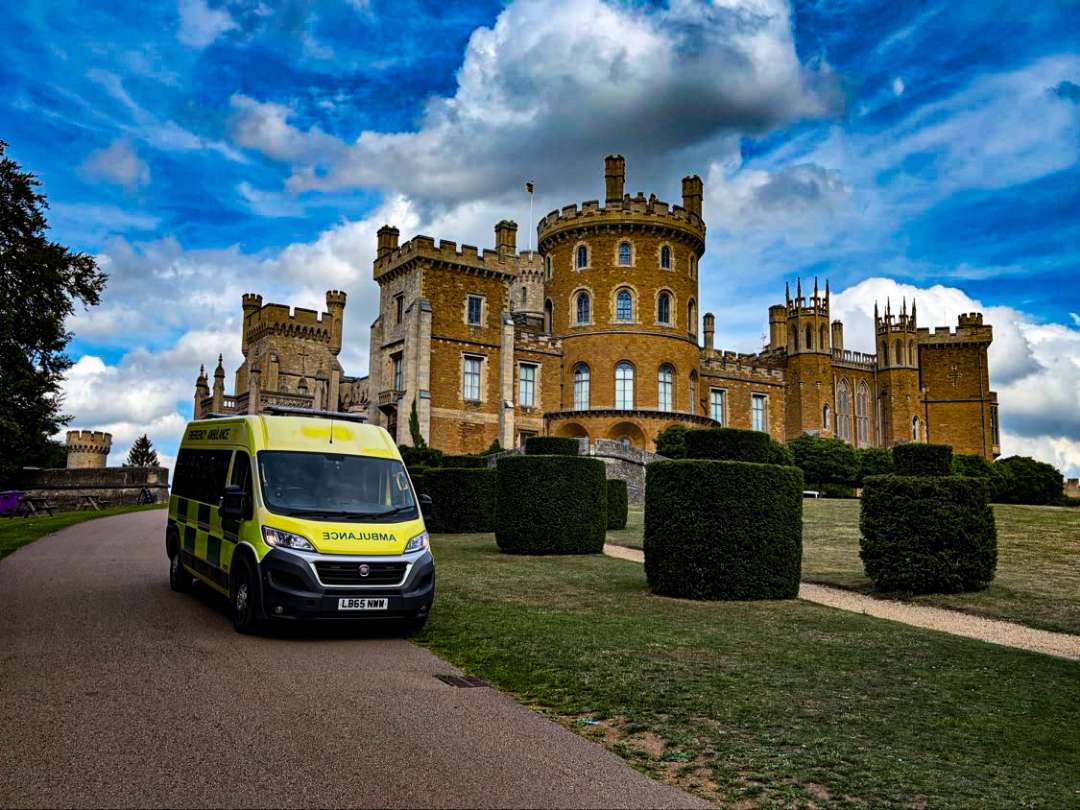 A BelvoirCare ambulance parked in front of Belvoir Castle, ready to provide event cover.