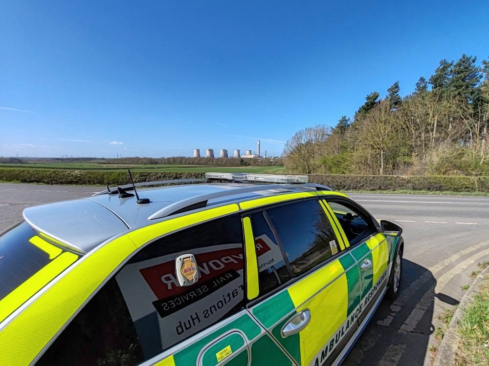 A BelvoirCare rapid-response car on standby at a rural roadside location.